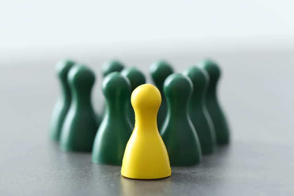 yellow pawn green ones gray table difference uniqueness concept